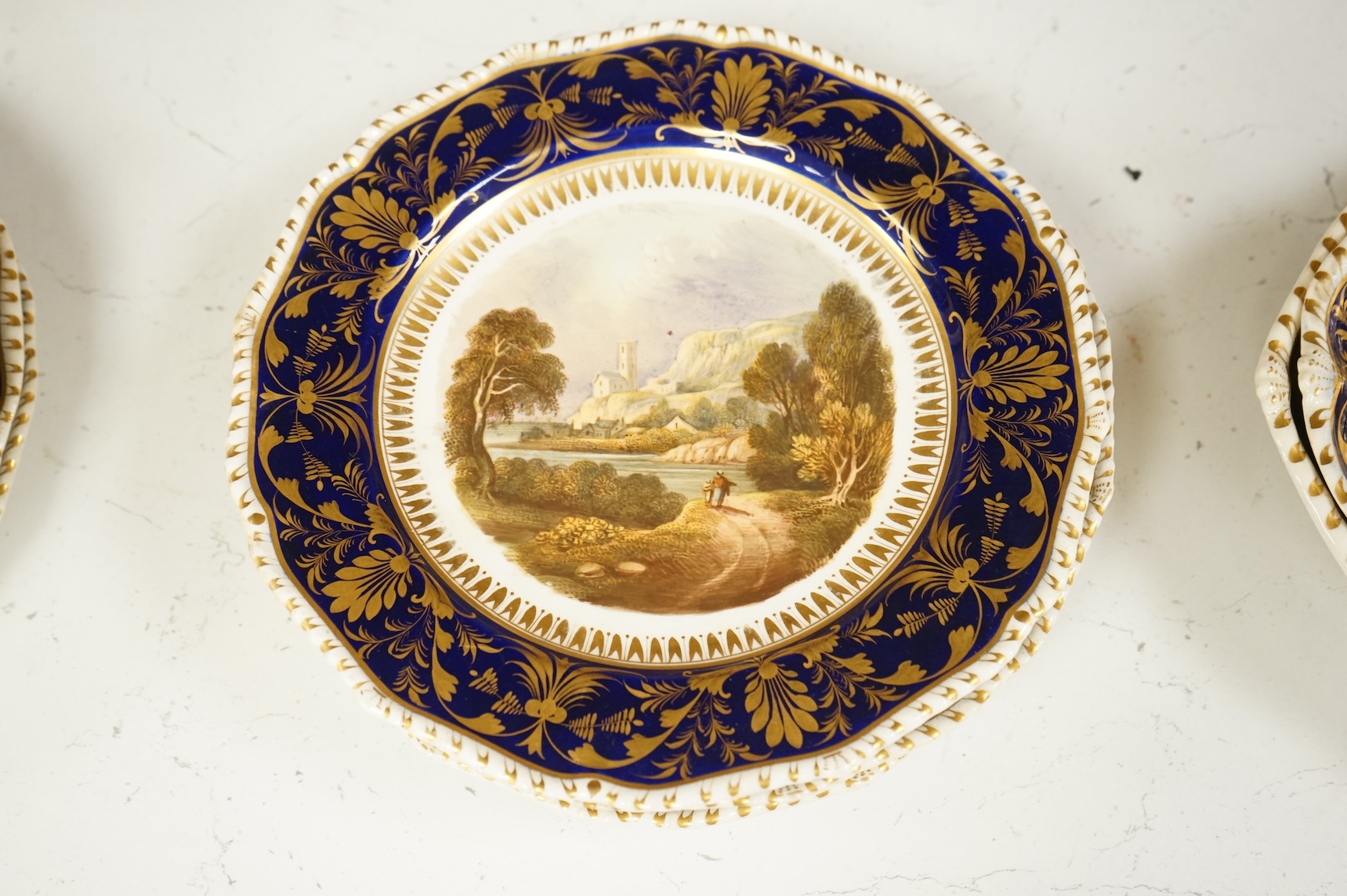 A Bloor Derby titled view part dessert service, c.1820 to include View on the Wye and View in Yorkshire, largest 29cm wide (16)